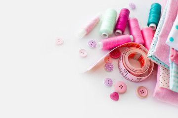 Accessories for sewing lie on a white background. Measuring tape