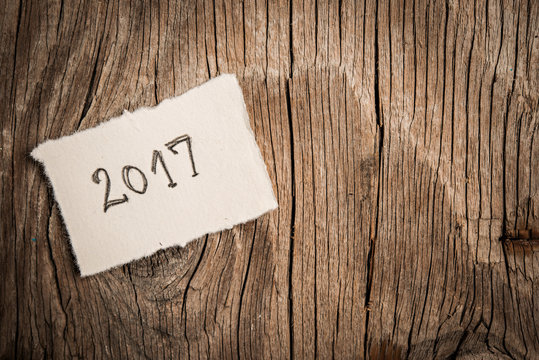 Happy New Yera 2017 on rustic wooden background
