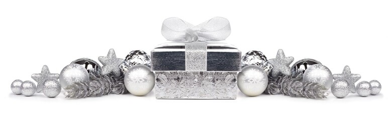 Christmas border of silver ornaments and gift isolated on a white background