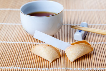 Broken Fortune Cookie with Slip and Chopsticks and Tea