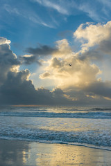 Beautiful morning sunrise over the ocean.  Soft waves break on the beach.  North Carolina. 