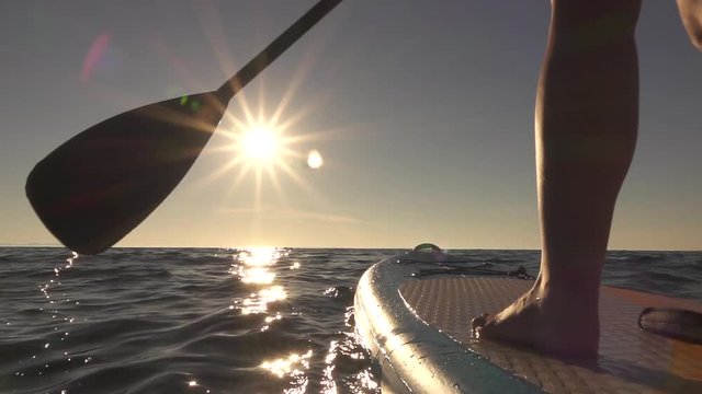 CLOSE UP: Detail Of Paddling Stand Up Paddleboard Through Sparkling Ocean Water