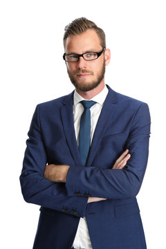Attractive businessman standing in a blue suit and tie, wearing glasses. White background.