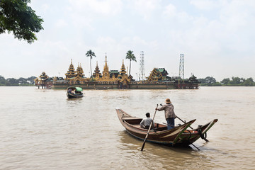 Fototapeta na wymiar people cross yangon river by boat for pray at Ye Le Paya pagoda the floating pagoda on small island in Yangon Myanmar (Burma)