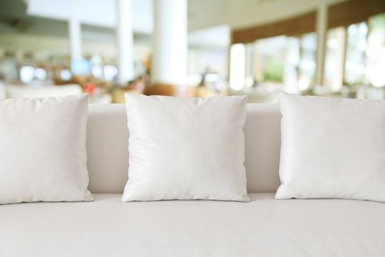 White square pillow on white sofa