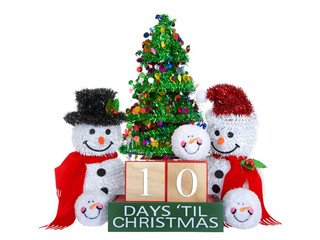 10 Days until Christmas light beech wood blocks with red trim on a green base with tinsel christmas tree, mr and mrs snowman and snowball snowmen heads isolated on a white background.