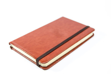 Small brown notebook isolated in white background.