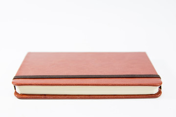 Small brown notebook isolated in white background.
