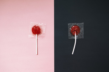 lollipops on pink and black background. the contrast between the whole and broken candy lollipop....