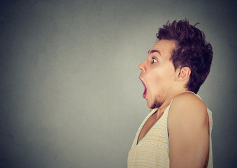 Closeup portrait shocked young man