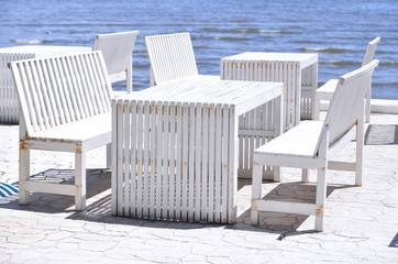 Fototapeta na wymiar Tables and chairs near the sea