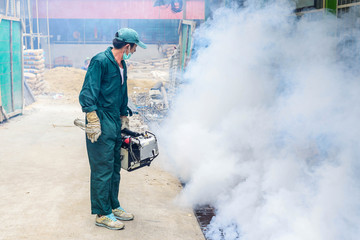 Man work fogging to eliminate mosquito for prevent spread dengue fever and zika virus