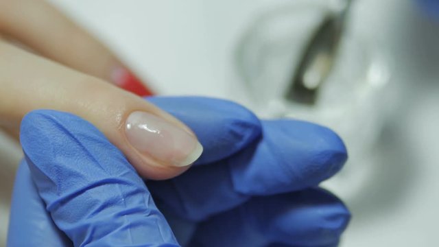 Manicurist handles cuticles with special nozzles