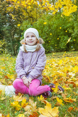 Girl under falling yellow leaves