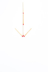 Matches stick arranged in arrow sign close up isolated.