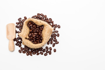 Organic coffee beans in sack on white background close up isolated.