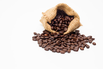Organic coffee beans in sack on white background close up isolated.
