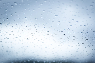 Rain drop on car glass in background.