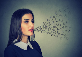 Woman talking with alphabet letters coming out of her mouth