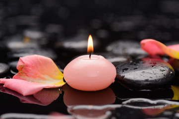 rose petals with  pink candle and therapy stones 