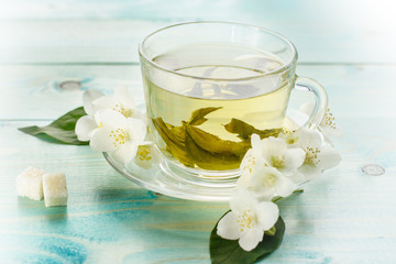 Green herbal tea with jasmine flowers, closeup