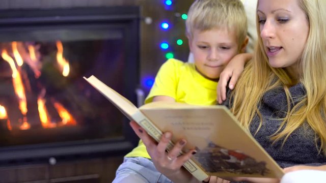 mom and kids reading book at christmas time