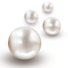 Four pearls with narrow depth of field isolated on white background