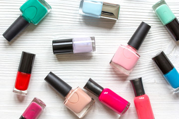 Obraz premium lot of bottles nail polish on wooden background top view