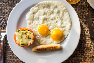 Breakfast with egg and sausage .