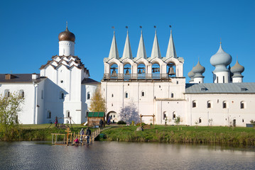 View of a belfry and Church of the Intercession of the Tikhvin Uspensky monastery in the sunny october afternoon. Tikhvin, Russia
