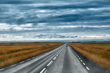 Empty road leading to snow covered mountains, Beautiful landscape in early autumn of Iceland