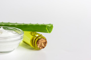 extract from aloe vera in glass bottle and cream macro