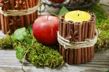 Candle decorated with cinnamon sticks
