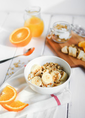 healthy breakfast bowl of yogurt with granola and banana