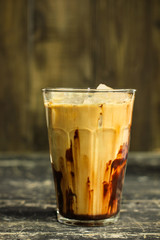 Iced coffee with chocolate on the wood table.
