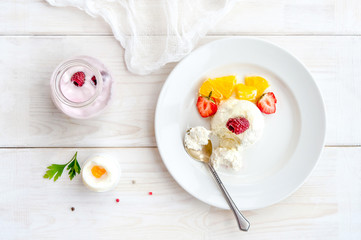 Ice cream with berries on white plate top view