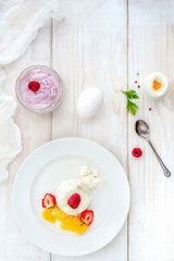 Ice cream with berries on white plate top view