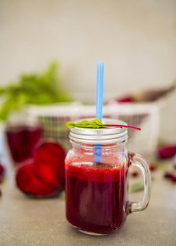 Beetroot juice in a mason jar mug on grey stone background. Detox and healthy diet. 