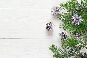 Fir branches with cones on a white painted wooden boards. Christ
