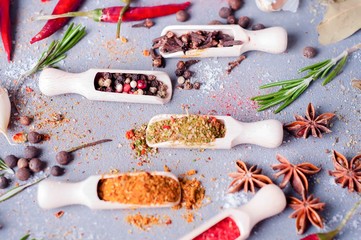 Aromatic spices on wooden spoons.