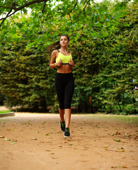 Young woman running in green park, fitness outdoor