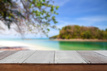 Wood table top on beach background.