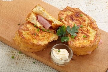 Fresh toasts with ham cheese on wooden board