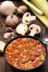 Beef stew soup on a wooden background