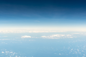 Naklejka na ściany i meble Cloudscape skyline view above white clouds from airplane