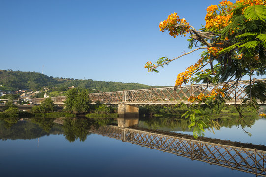 Scenic postcard view of the rustic Dom Pedro II iron bridge joining the historic town of Cachoeira with São Félix, divided by the Rio Paraguaçu River in Bahia, Brazil
