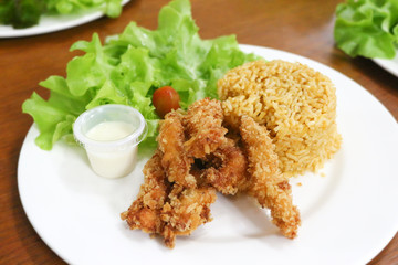 fried rice and breaded fried chicken in white plate