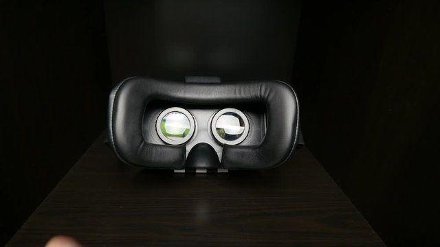 Virtual reality mask. Male hands taking a virtual reality headset. 