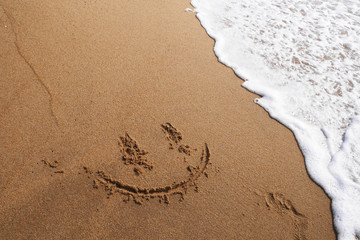 Smile face on sand