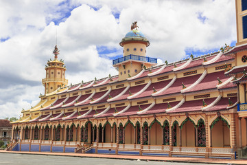TAY NINH, VIETNAM - October 23, 2016:Cao Dai temple area and meditating followers of the Cao Dai religion in the temple Cao Dai